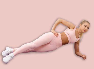 Fitness woman doing side planking exercise, workout. Slim athletic girl training plank