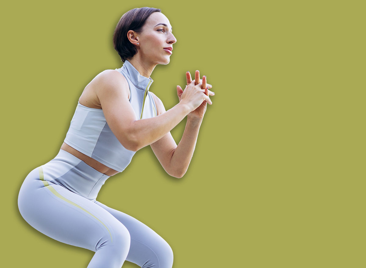 Woman engaging in a squat exercise outdoors, focusing on strength training and maintaining a healthy, active lifestyle