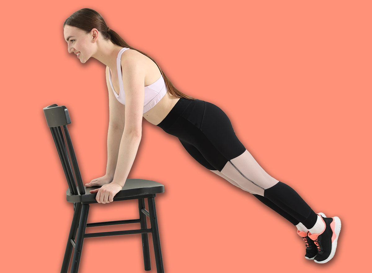 Beautiful woman exercising with chair at home