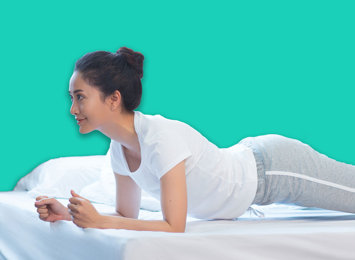 Asian women exercising in bed in the morning, she feels refreshed.She acted plank