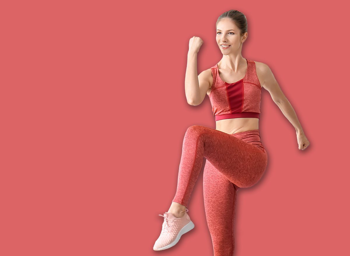 Sporty young woman training at home