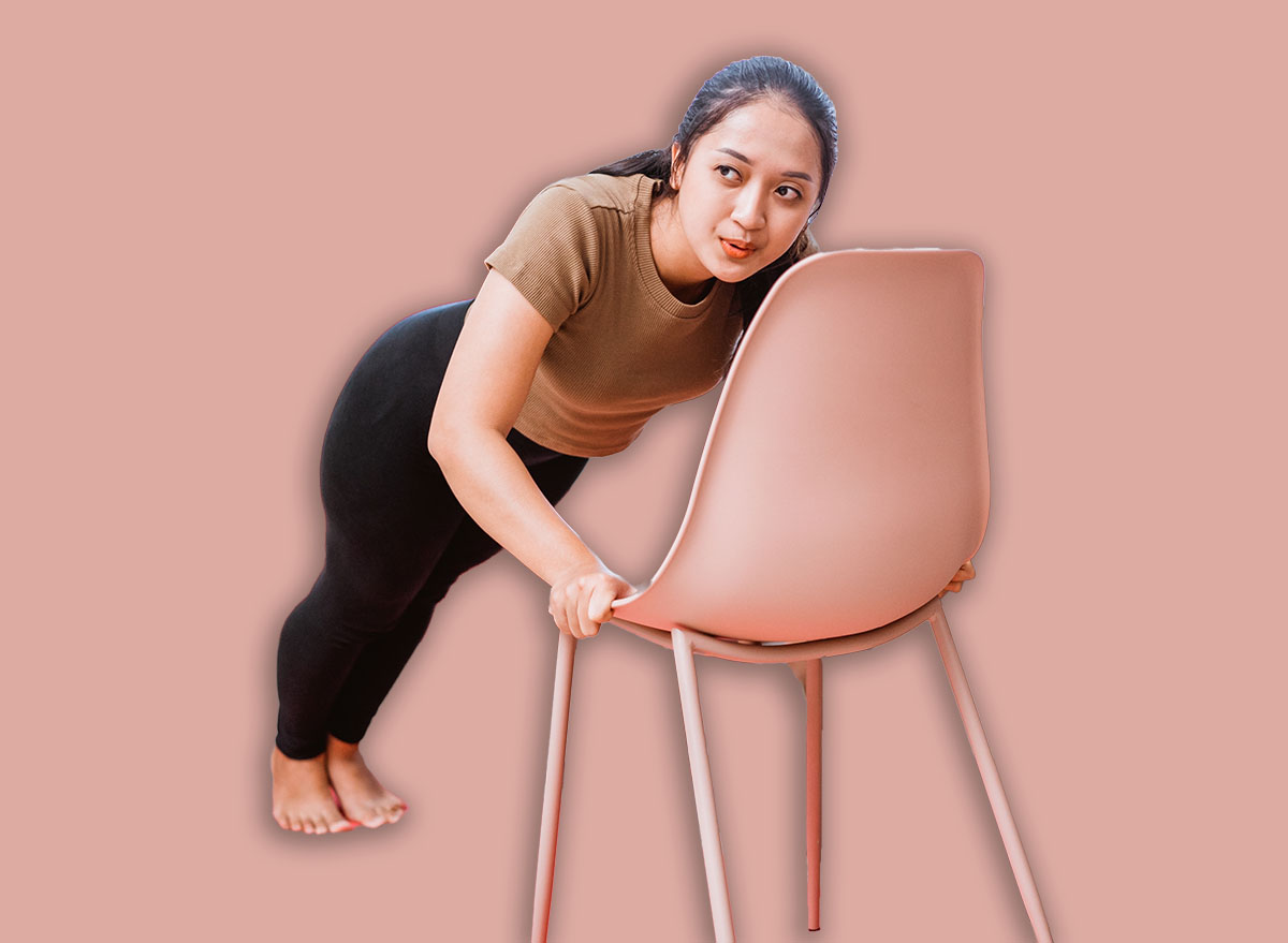 modern young asian couple exercising at home using chair to help them workout