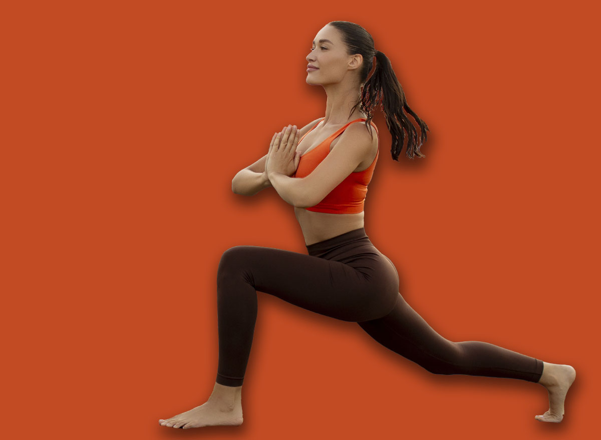 Young woman performing yoga in lunge position on mat outdoors, breathing and enjoying workout on hilltop with scenic view, copy space