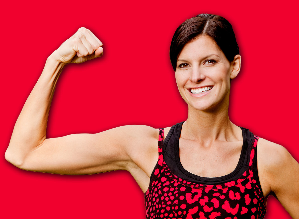 A pretty fitness model flexing her bicep