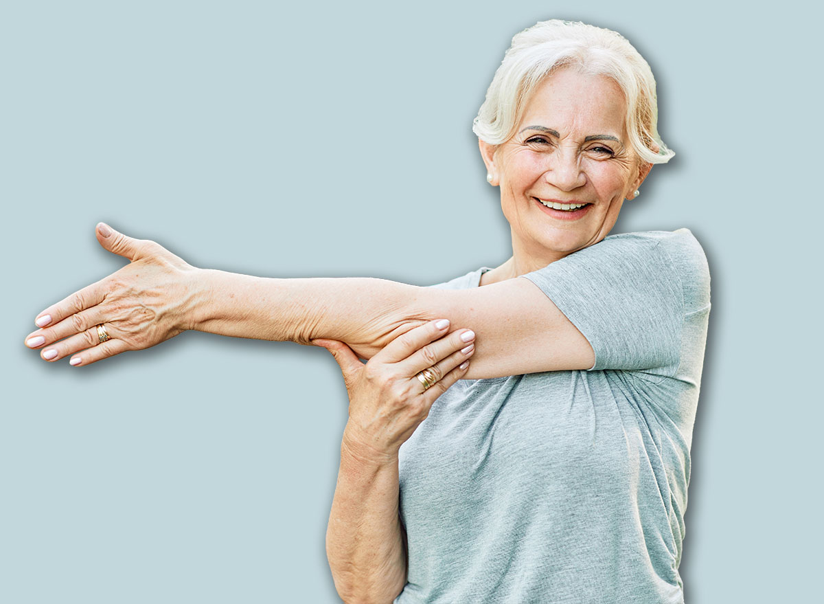 Portrait os a happy beautiful elderly senior mature woman exercising and stretching outdoors
