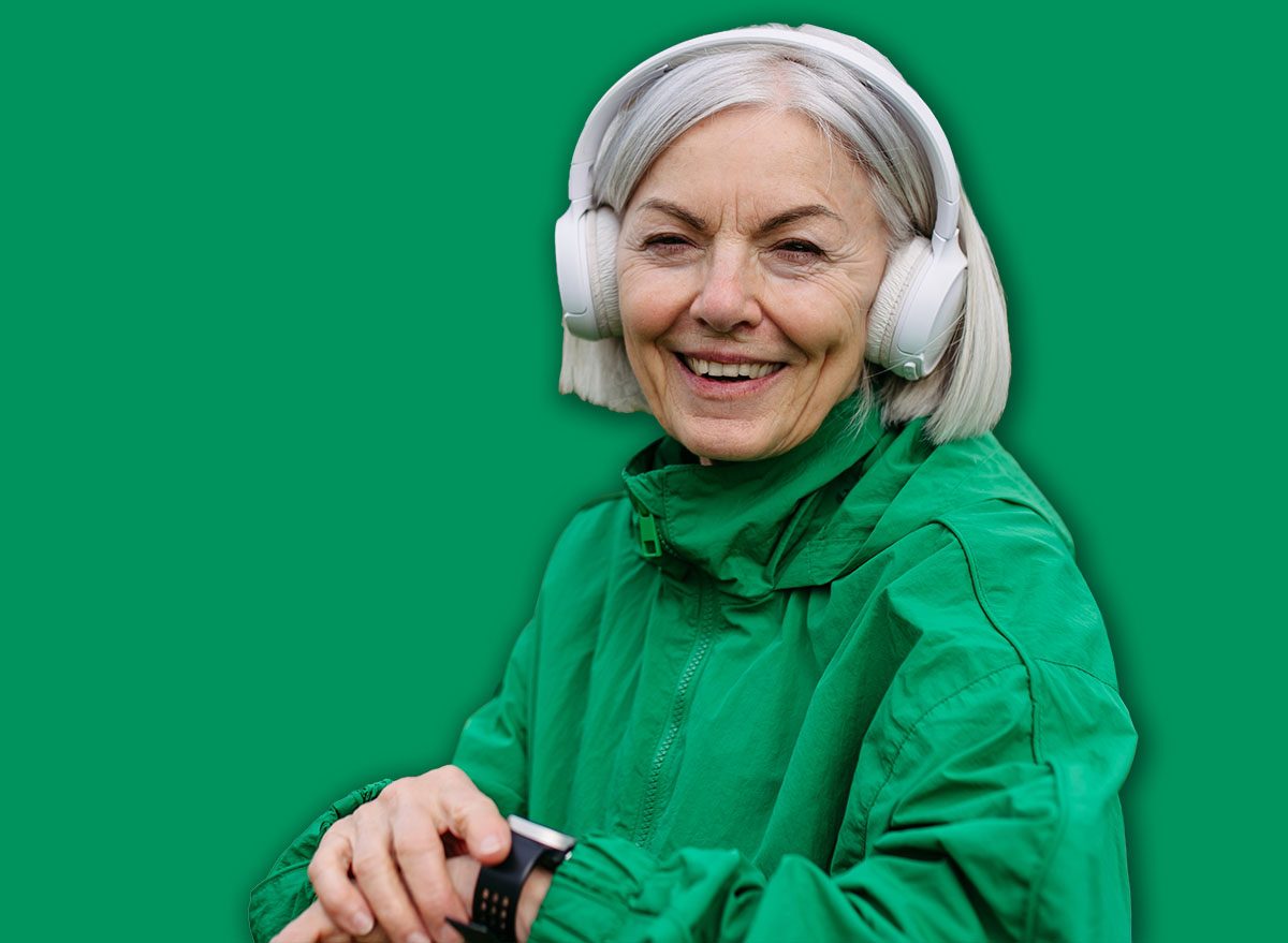 Mature woman checking her performance on smartwatche after run. Exercising after work for good mental health, physical health, relieving stress and boost mood.