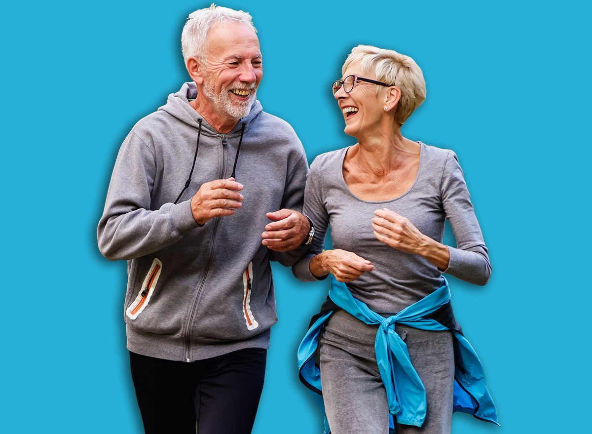Cheerful active senior couple jogging in the park. Exercise together to stop aging.