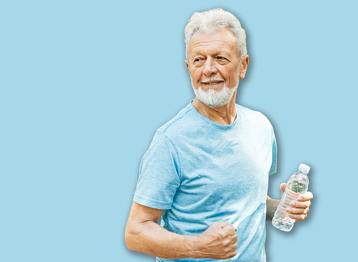 Active senior man running jogging exercising in the park