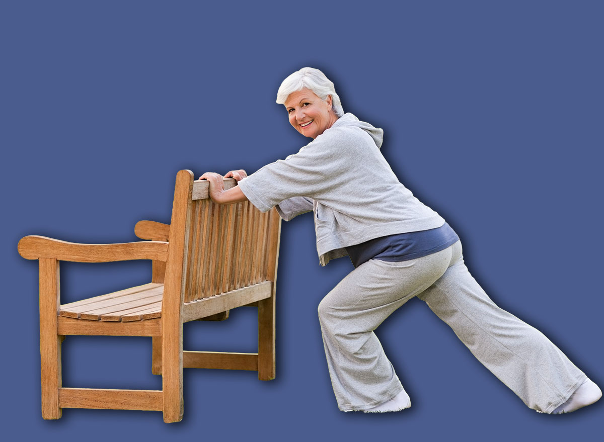 Senior woman doing her stretches in the park
