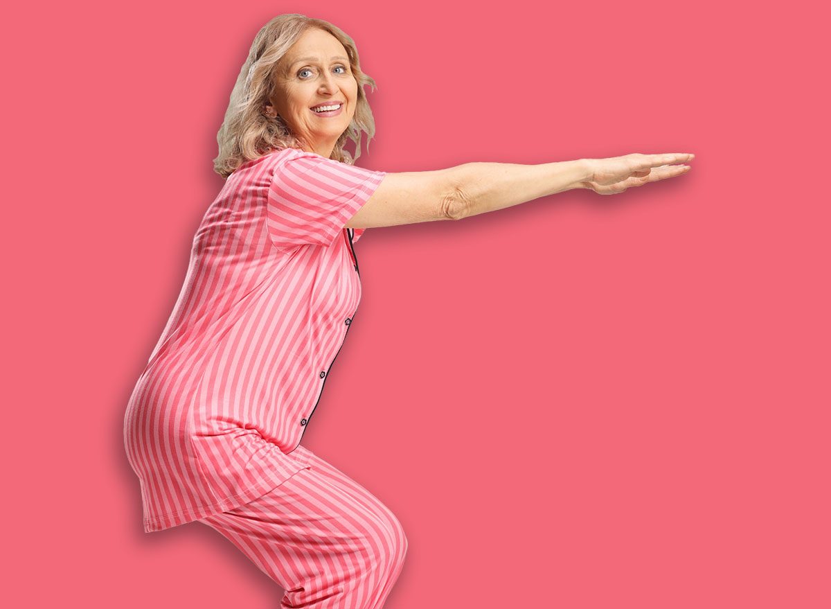 Woman in pajamas doing exercise at home