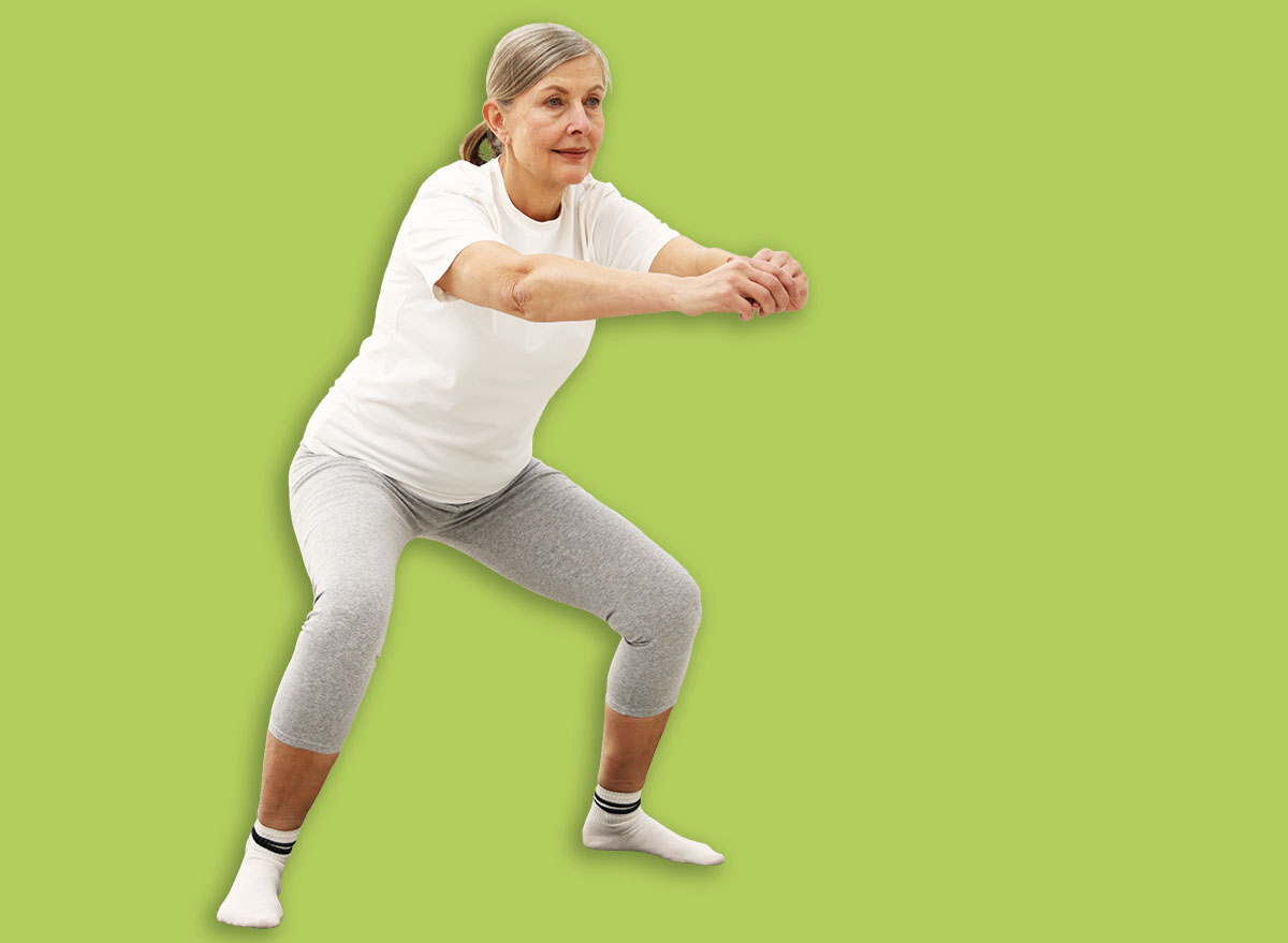 Senior woman exercising on mat at home. Fitness and sport