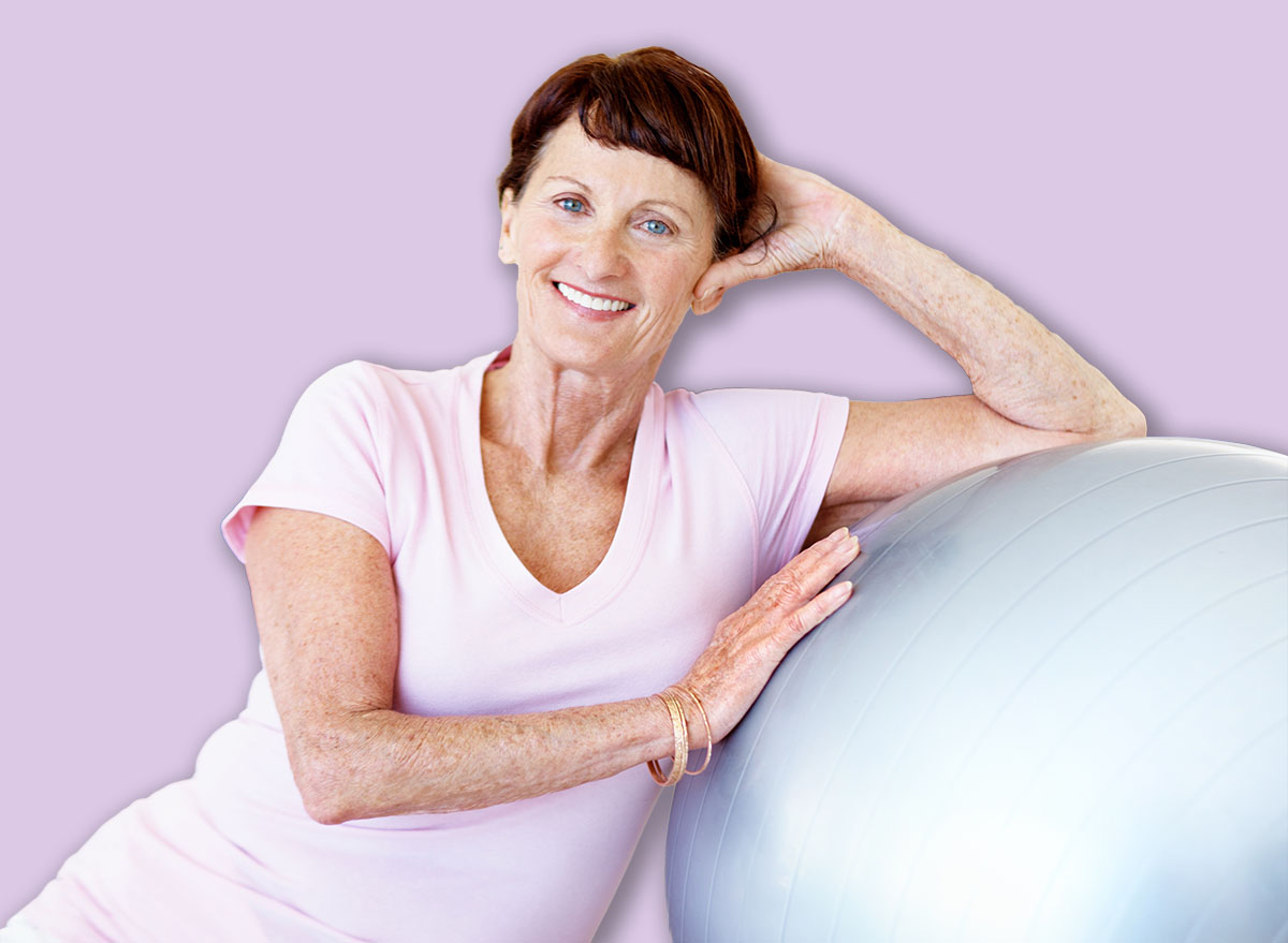 Portrait, fitness class and senior woman with ball for wellness, core strength and health. Smile, elderly person and pilates equipment at studio for active retirement, balance or stability exercise