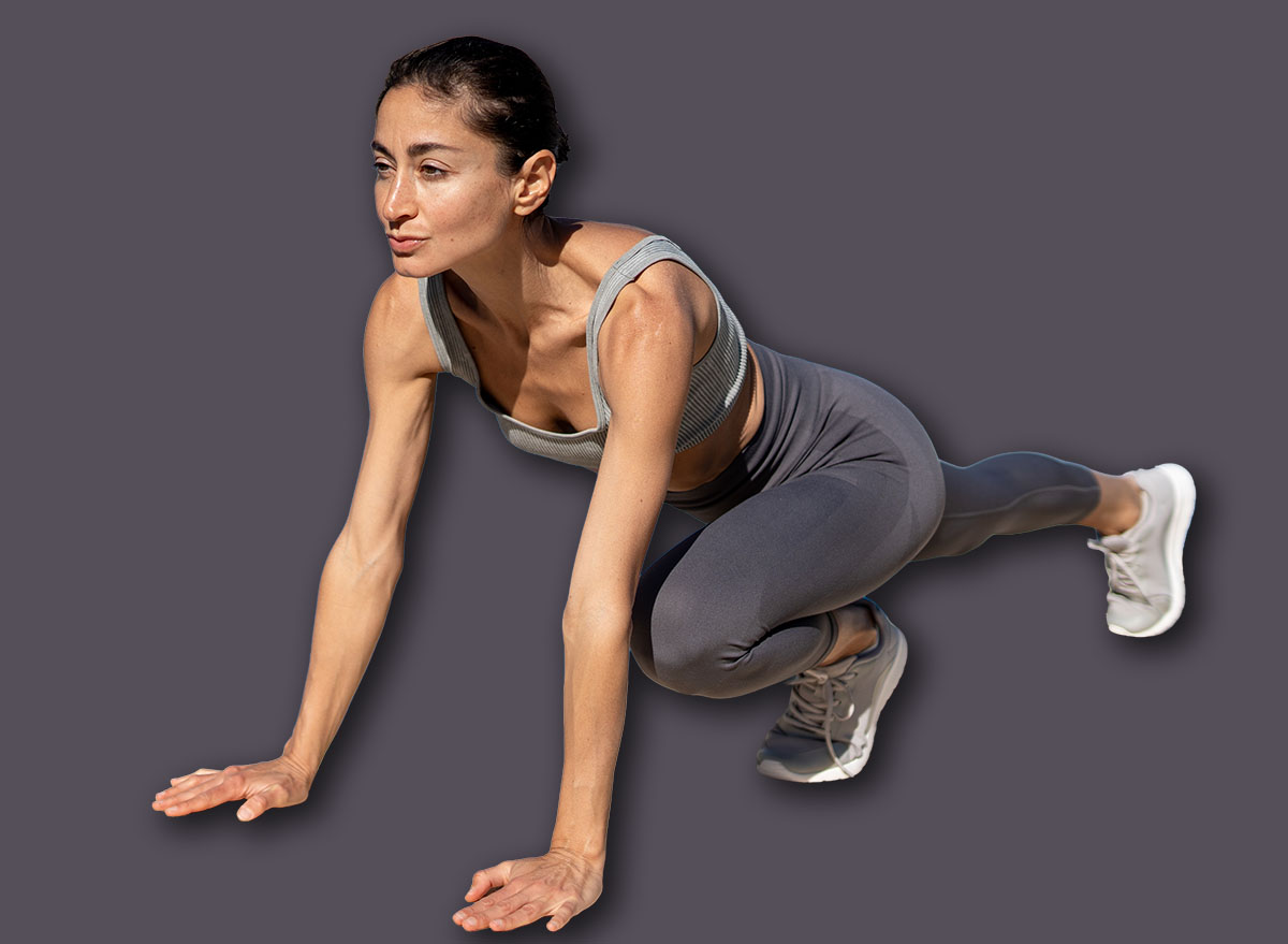 Woman performing mountain climber exercise by the pool in fitnes
