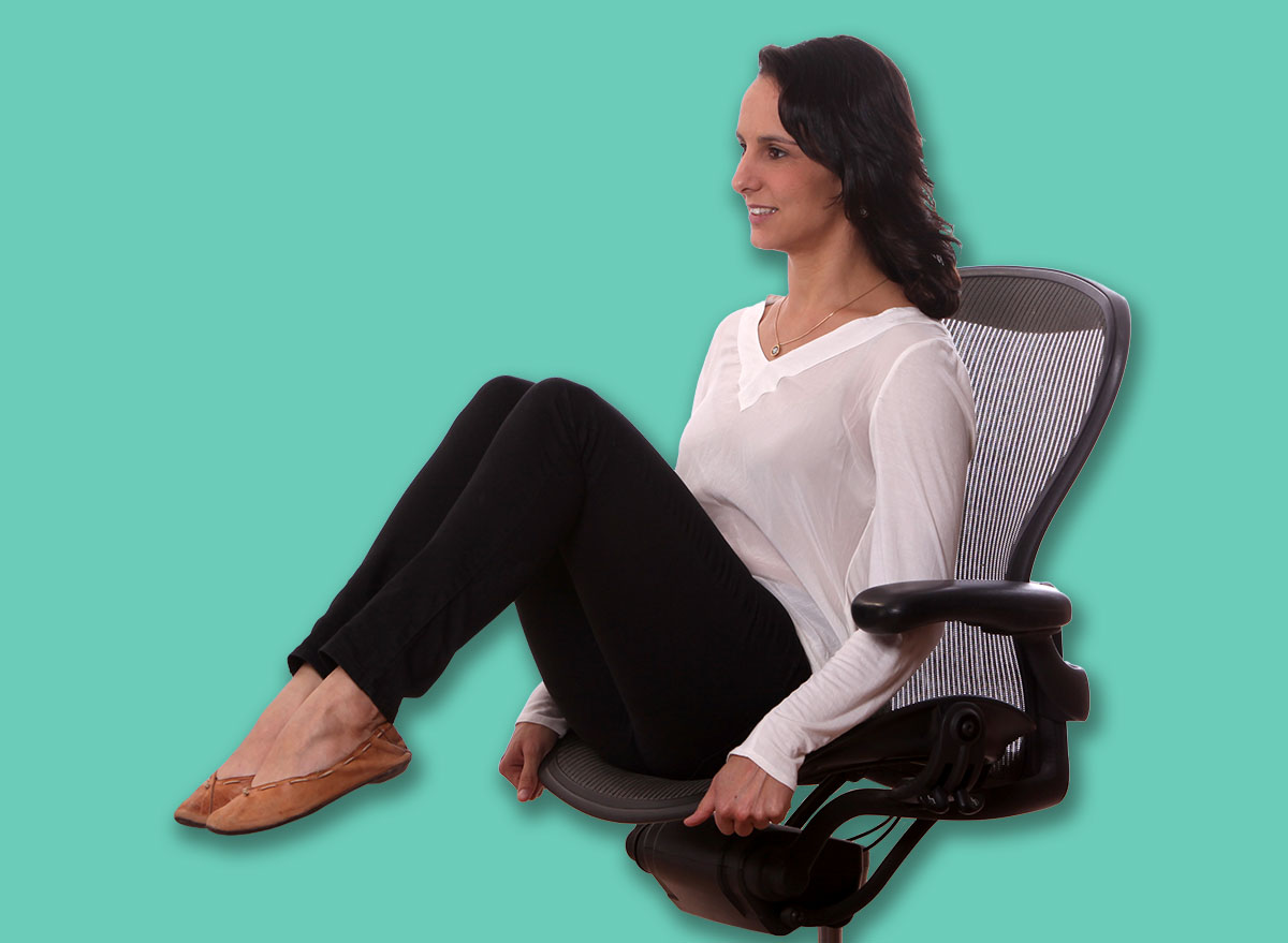 female manager stretching up on her chairs office .