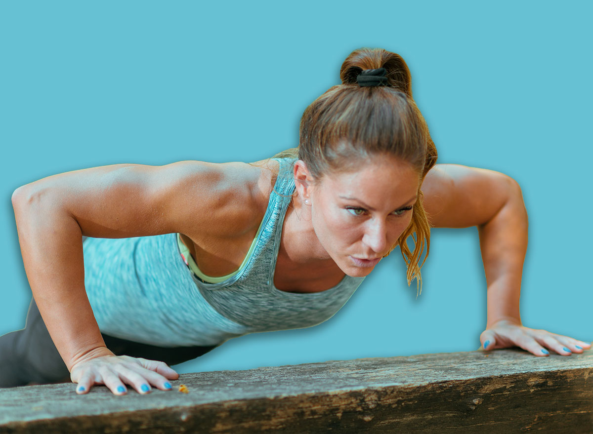 Woman doing push ups in the park, in the fall in Public Park