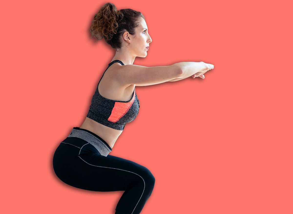 Shot of attractive sporty young woman doing hypopressive exercises in living room at home.