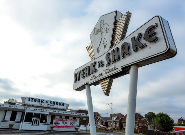 St. Louis, Missouri - September 9, 2020: The road sign in front of a closed vintage Steak-n-Shake.