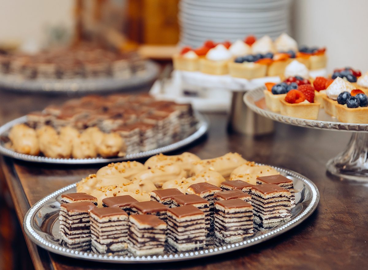 Different kinds of beautiful pastry, small colorful sweet cakes, macaron, and other dessert in the sweet buffet