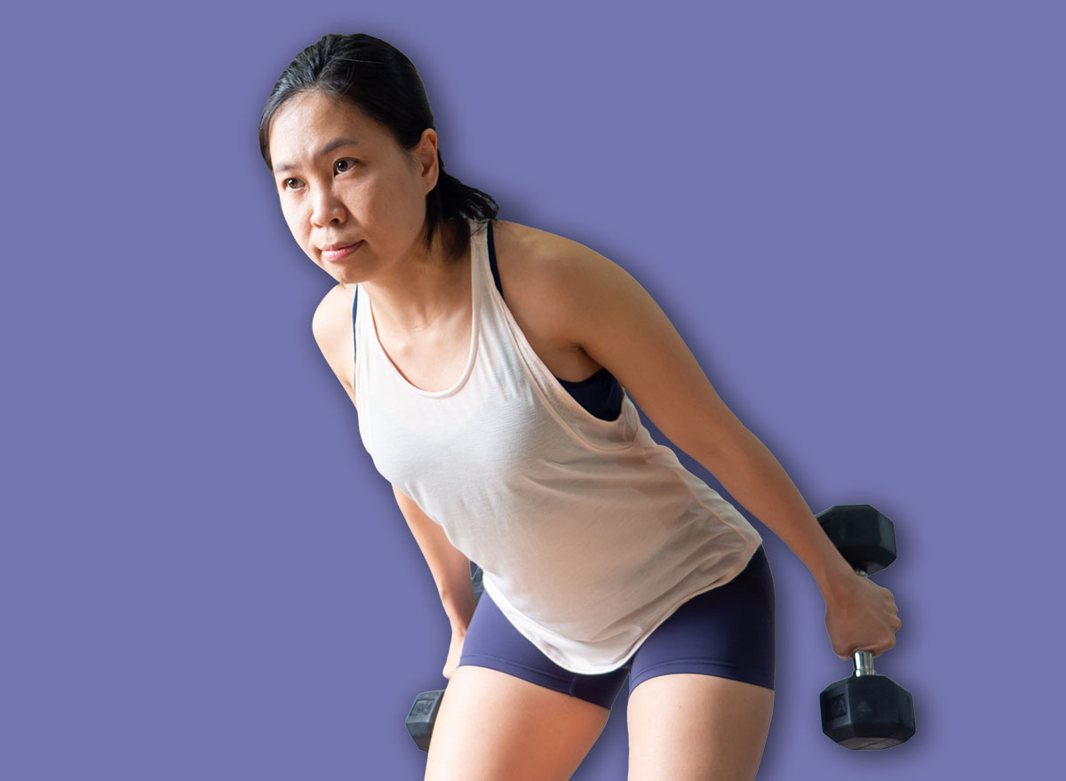 dumbbell tricep kickback squat position asian woman home workout fitness body weight exercise health training sport healthy lifestyle activity wellness care indoors natural light selective focus