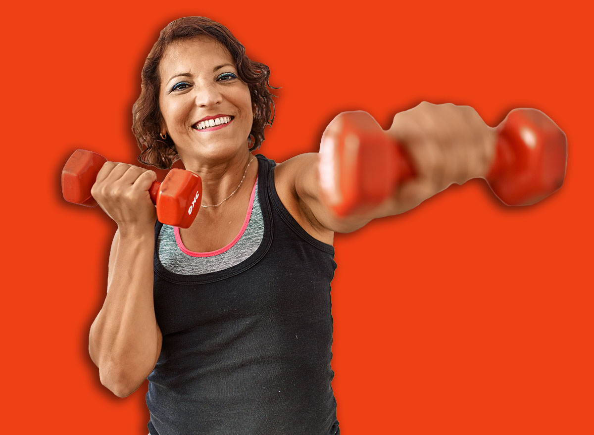 Middle age hispanic sporty woman smiling happy training using dumbbells at sport center.