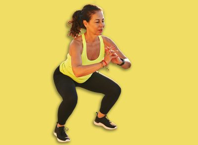 Middle age hispanic woman working out doing squats at promenade