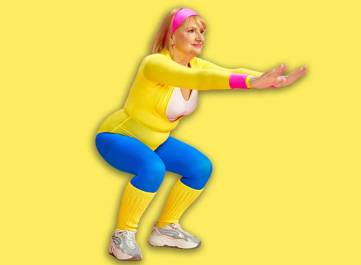 Elderly beautiful woman in colorful sportswear training, doing squats, posing against pink studio background. Keeping fit. Concept of sportive lifestyle, retirement, health care, wellness. Ad