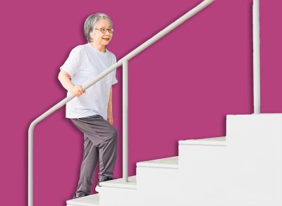 Elderly woman using stairs for rehabilitation (locomotive syndrome, frailty, sarcopenia, osteoporosis)