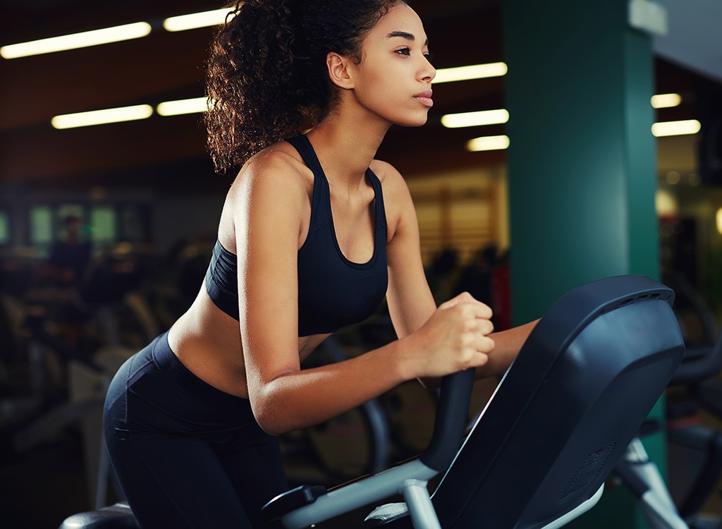 Woman on exercise bike - best ways to speed up your metabolism 
