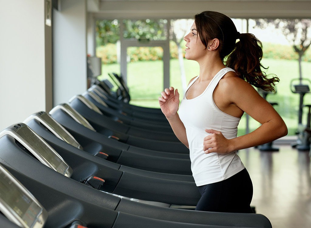 Woman running on treadmill - how to beat weight loss plateau