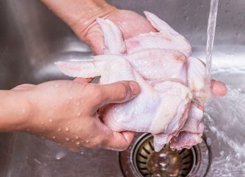 Woman washing chicken