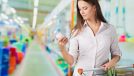 Woman looking at bottle in grocery store