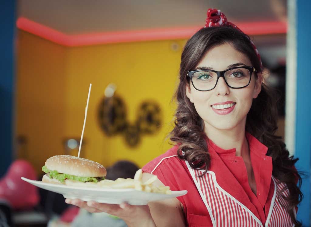 retro waitress serving burger