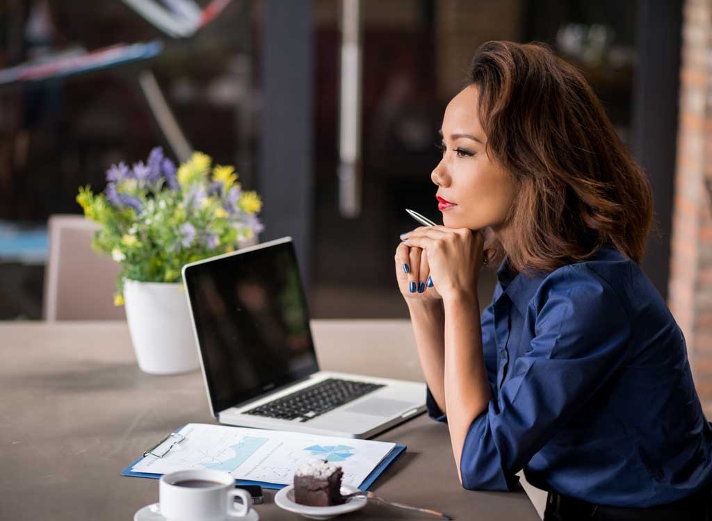 Woman at laptop thinking - stop thinking about food