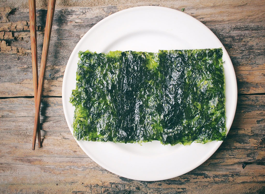 seaweed cracker on white plate with chopsticks