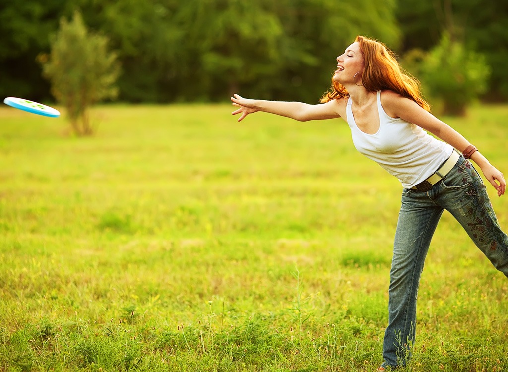 Woman playing frisbee in a park