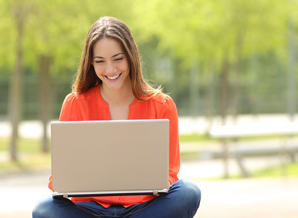woman sitting at computer outdoors