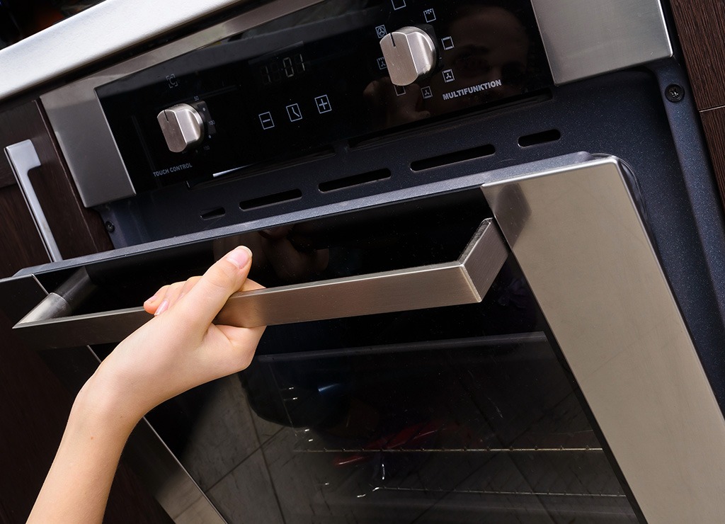 Woman opening oven