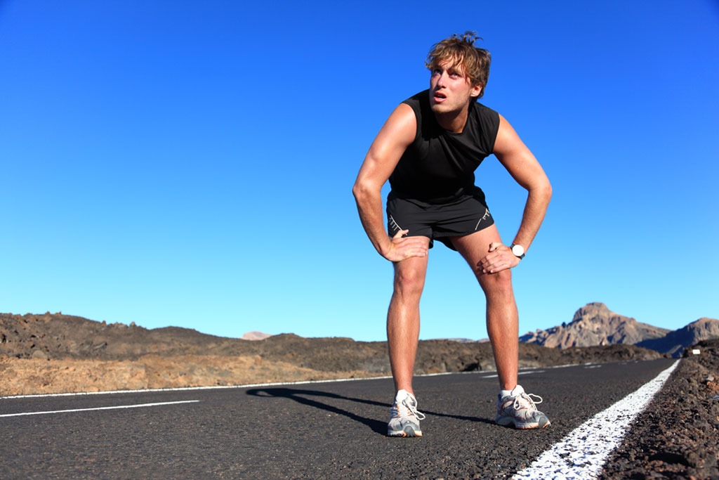 fit man resting on a run