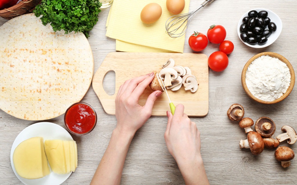 woman cutting mushrooms