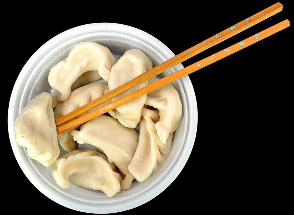 dumplings on white bowl with chopsticks