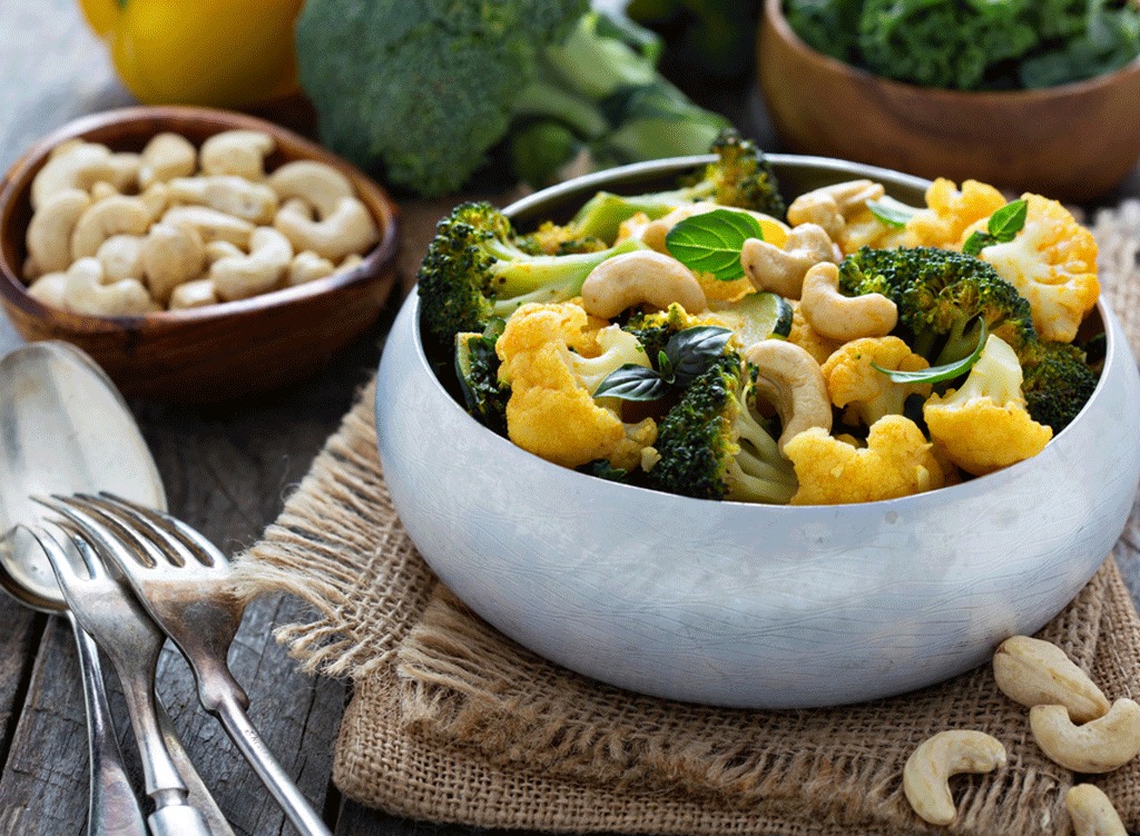 Curried cauliflower and broccoli with cashews in a bowl