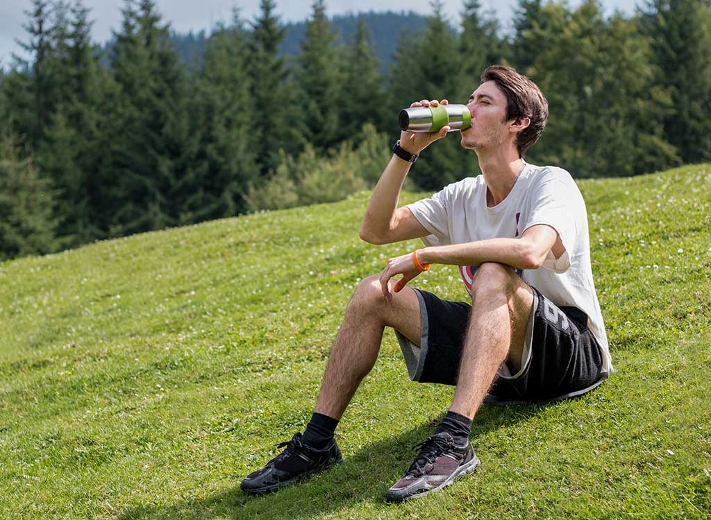 man drinking water bottle aluminum