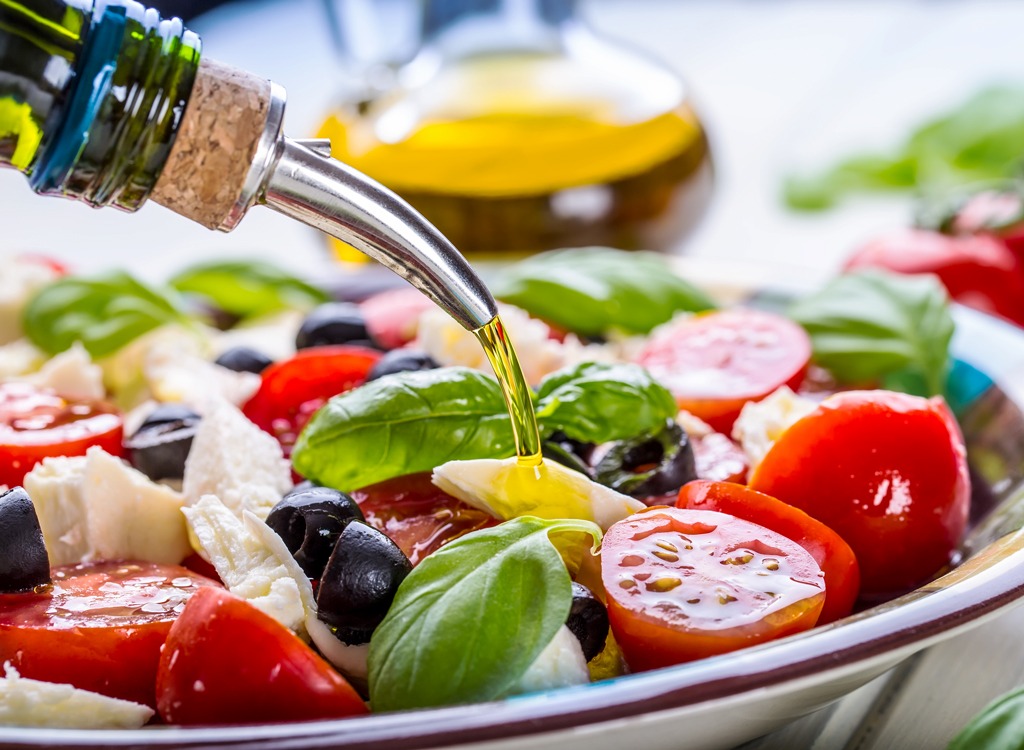 olive oil drizzled into salad