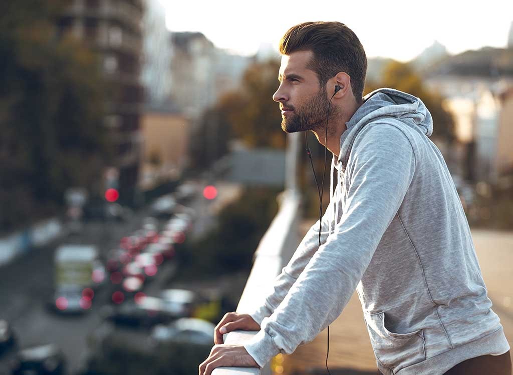 man with earbuds hoodie