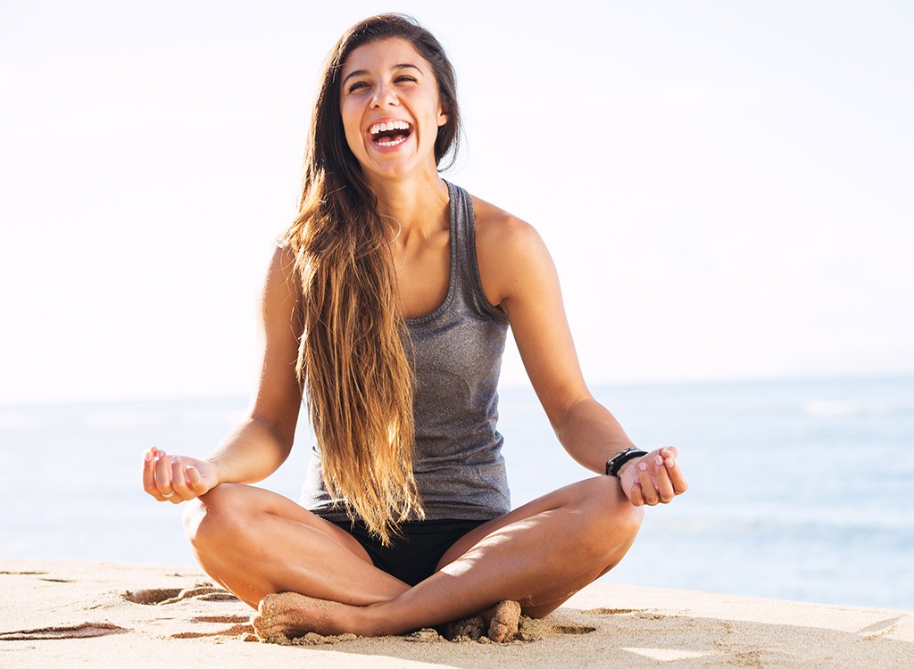 Laughing woman doing yoga