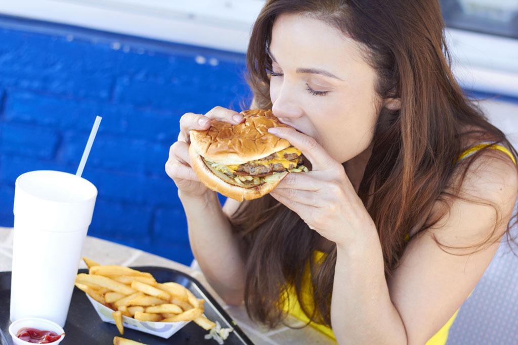 girl eating burger and fries