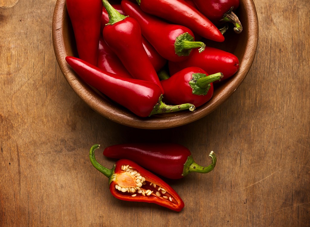 bowl of chili peppers with chili pepper sliced in half