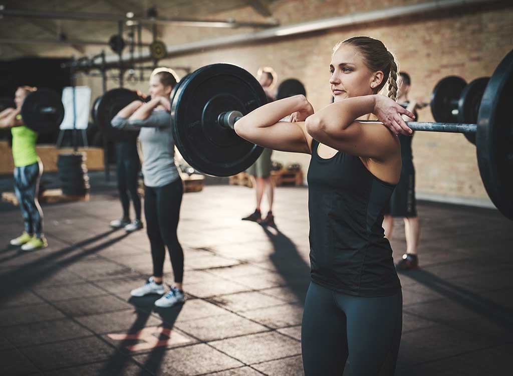 woman lifting large weight