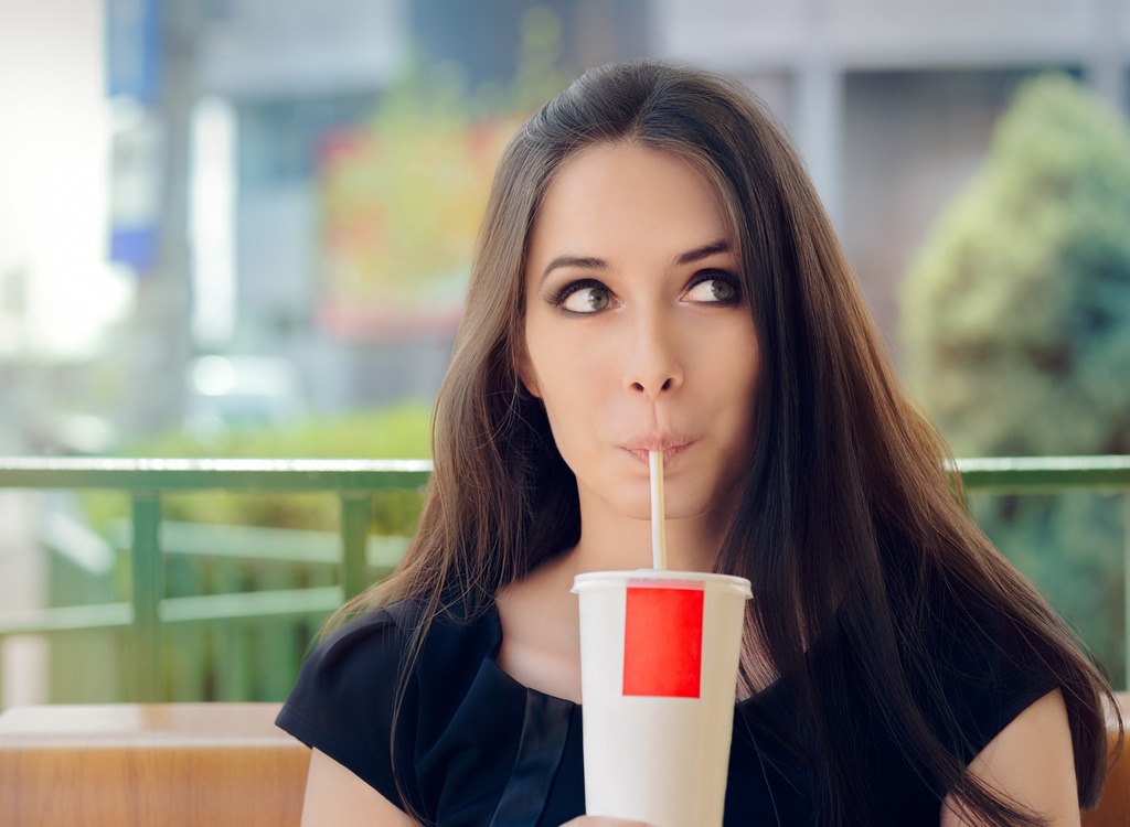 Woman sipping soda