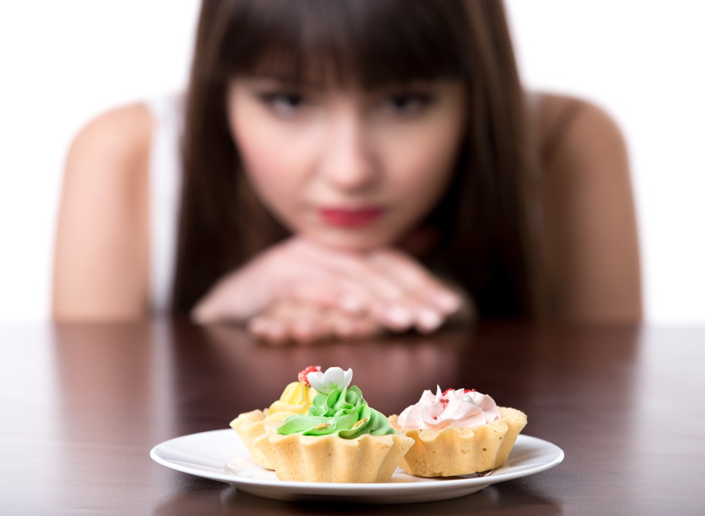 Woman staring at cupcakes